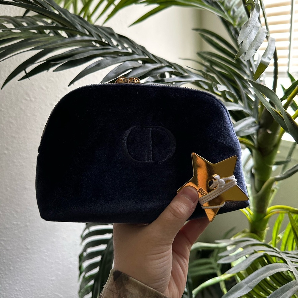 Christian Dior blue makeup bag and Dior Star bag charm